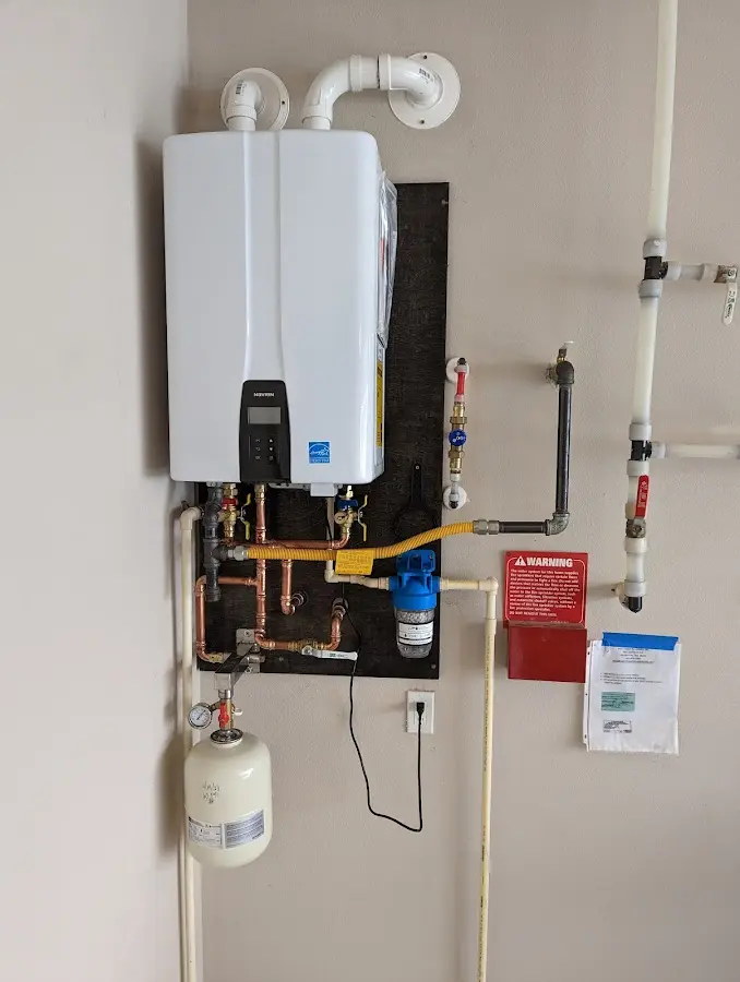 Professional plumber installing copper piping in a Overisel home